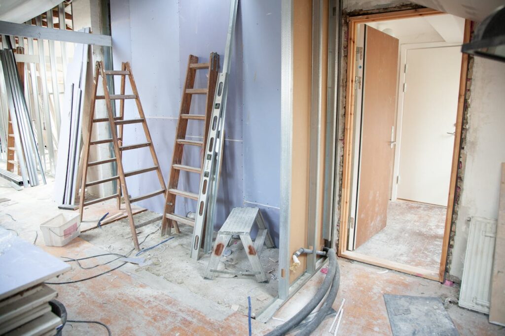 pexels-photo-3990359 Construction site featuring ladders and tools in a home renovation setting.